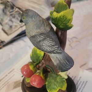 Decorative Bird Figurine with Green Leaves and Red Apples